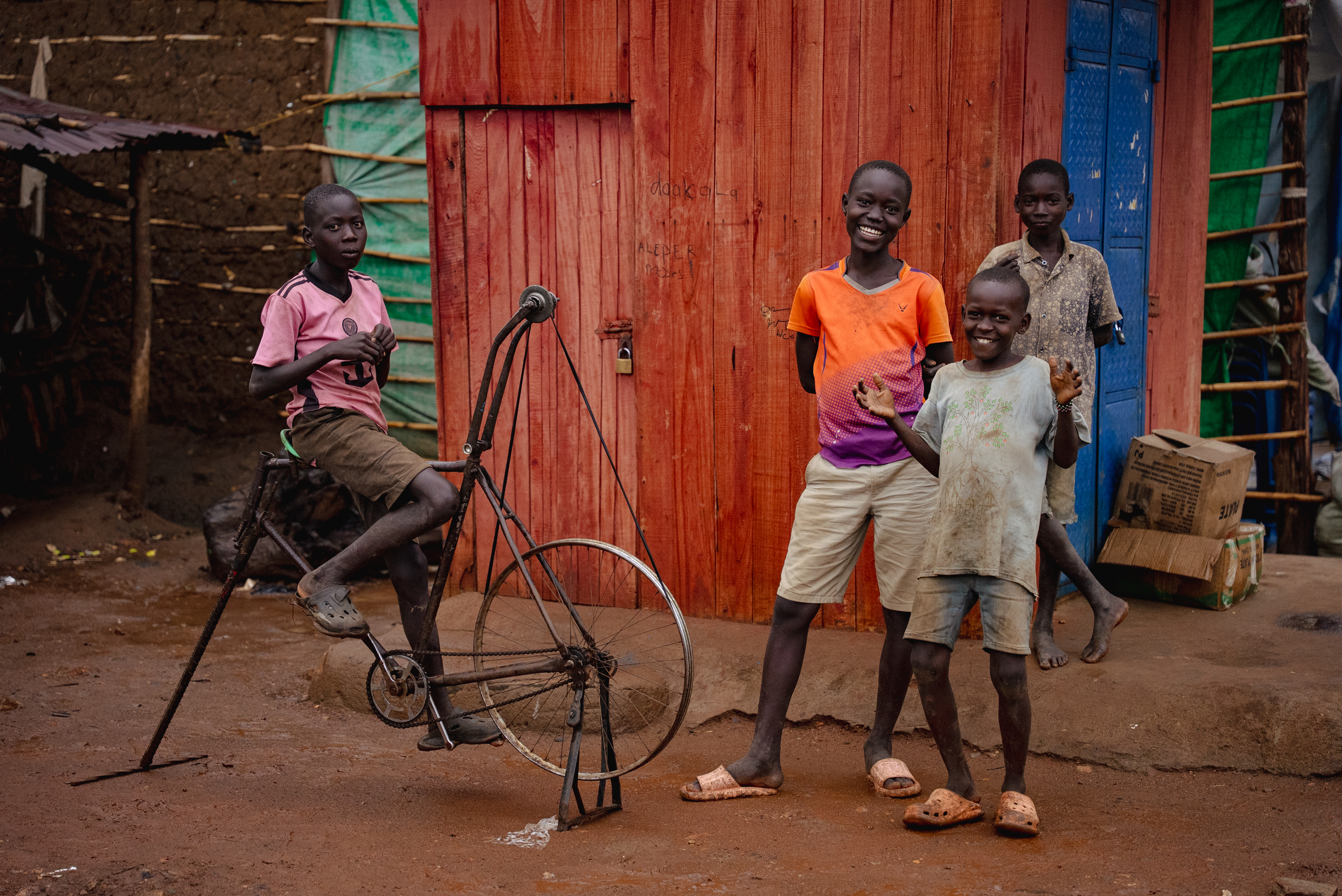 Boys playing with a bicycle in a trading centre