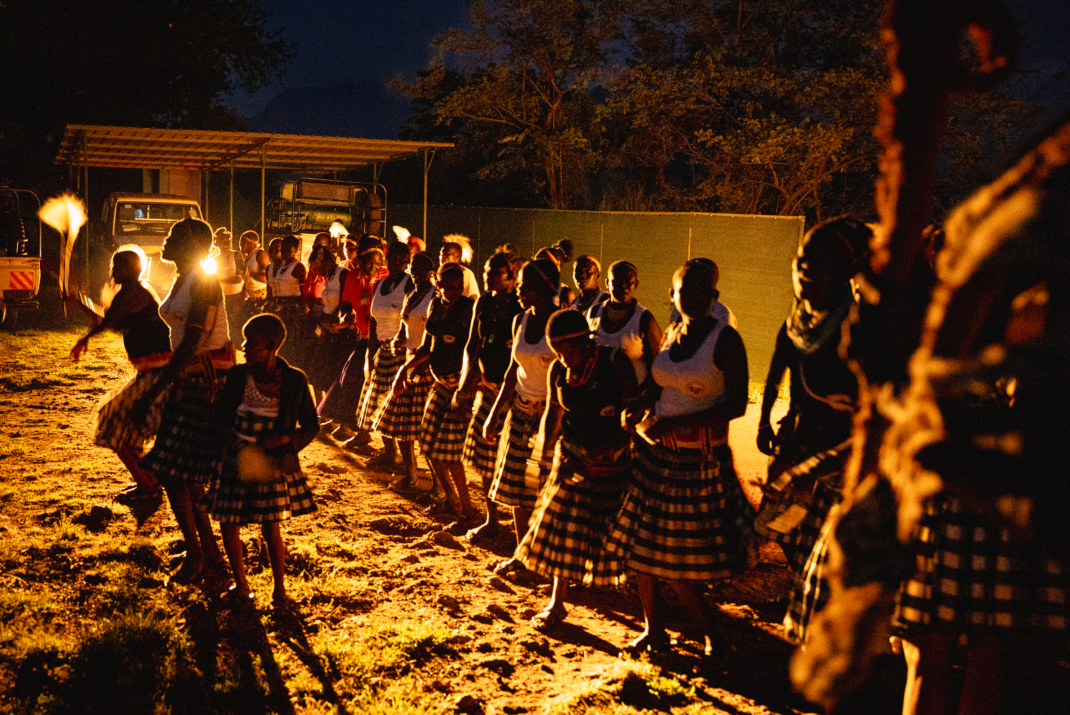 Women dancing by firelight at a community celebration