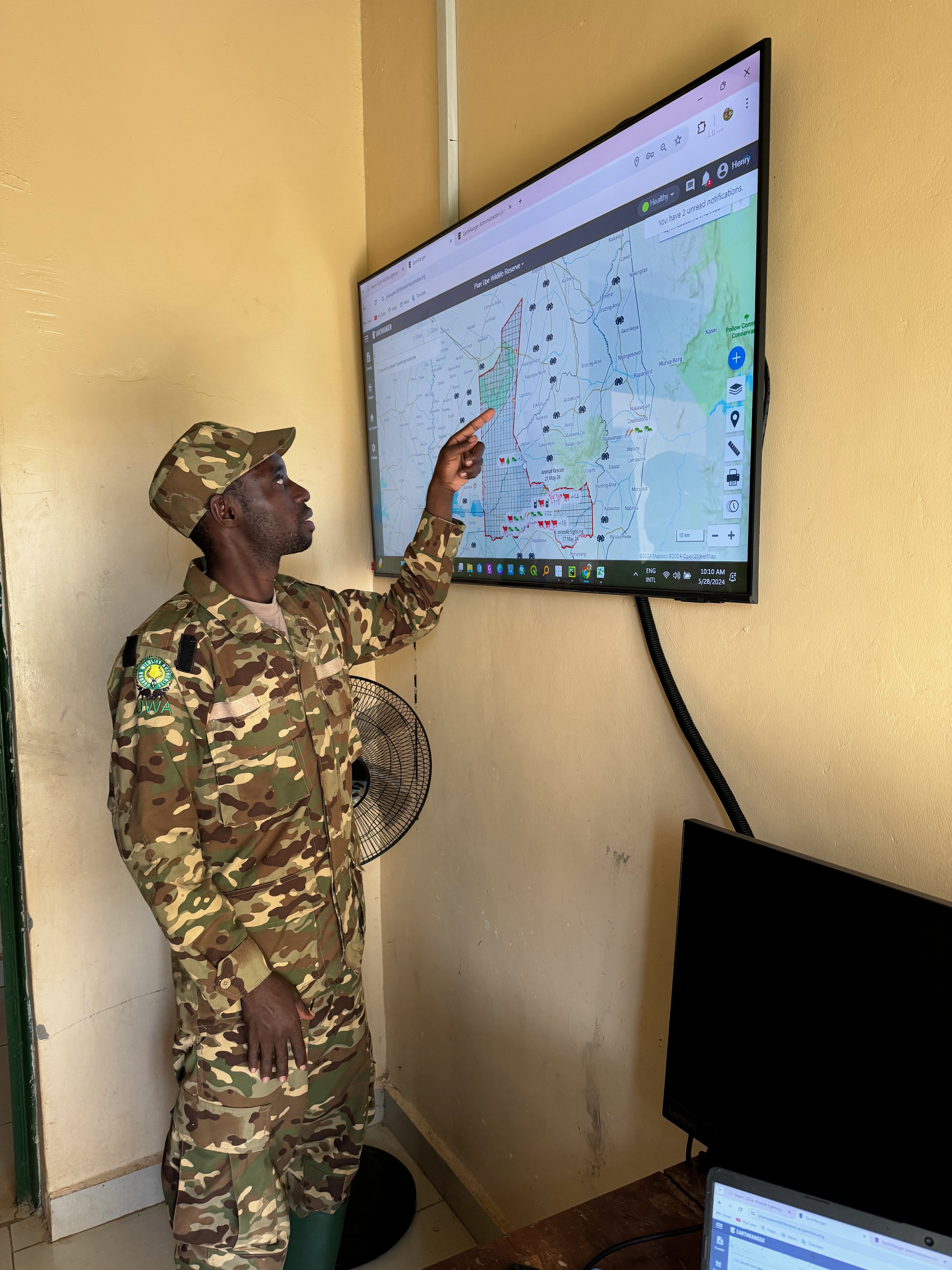 A ranger reviewing patrol data on the EarthRanger system