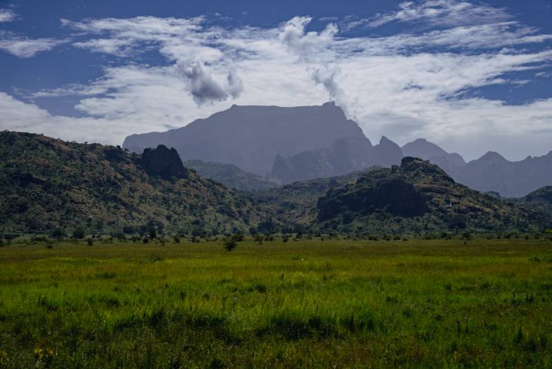 Woodland and river across the reserve with the mountains beyond