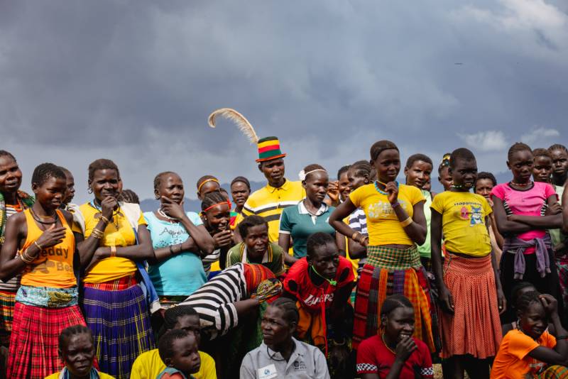 A community gathered under a stormy sky