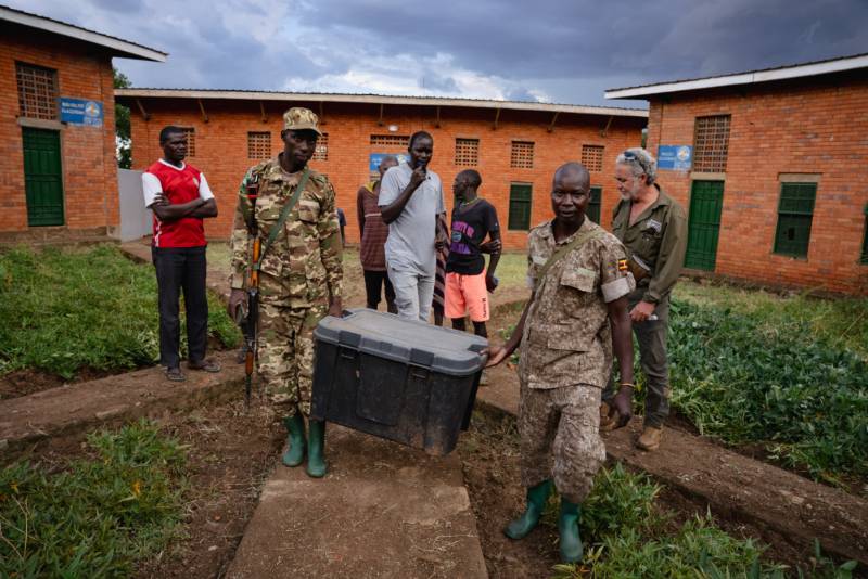 Rangers carrying a transport crate after a seizure